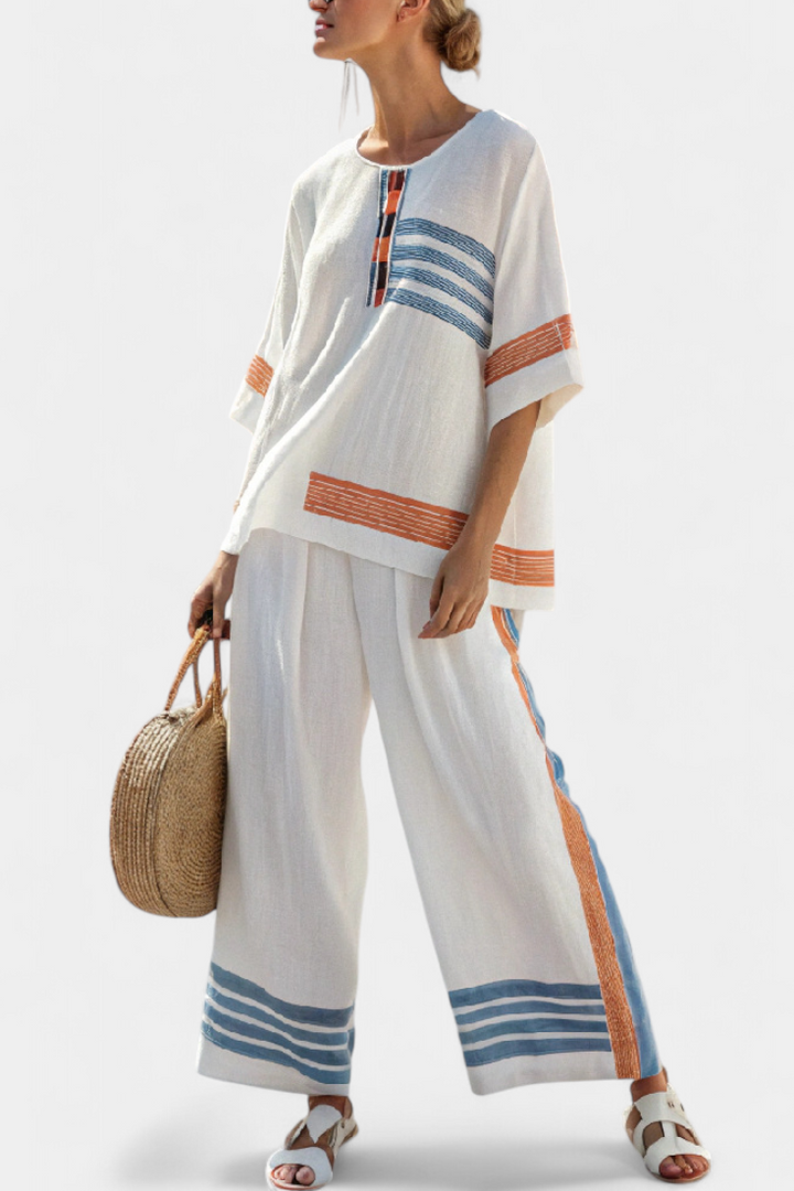 Daisy sæt i hvid med detaljer i blå og orange – unikt og livligt design
